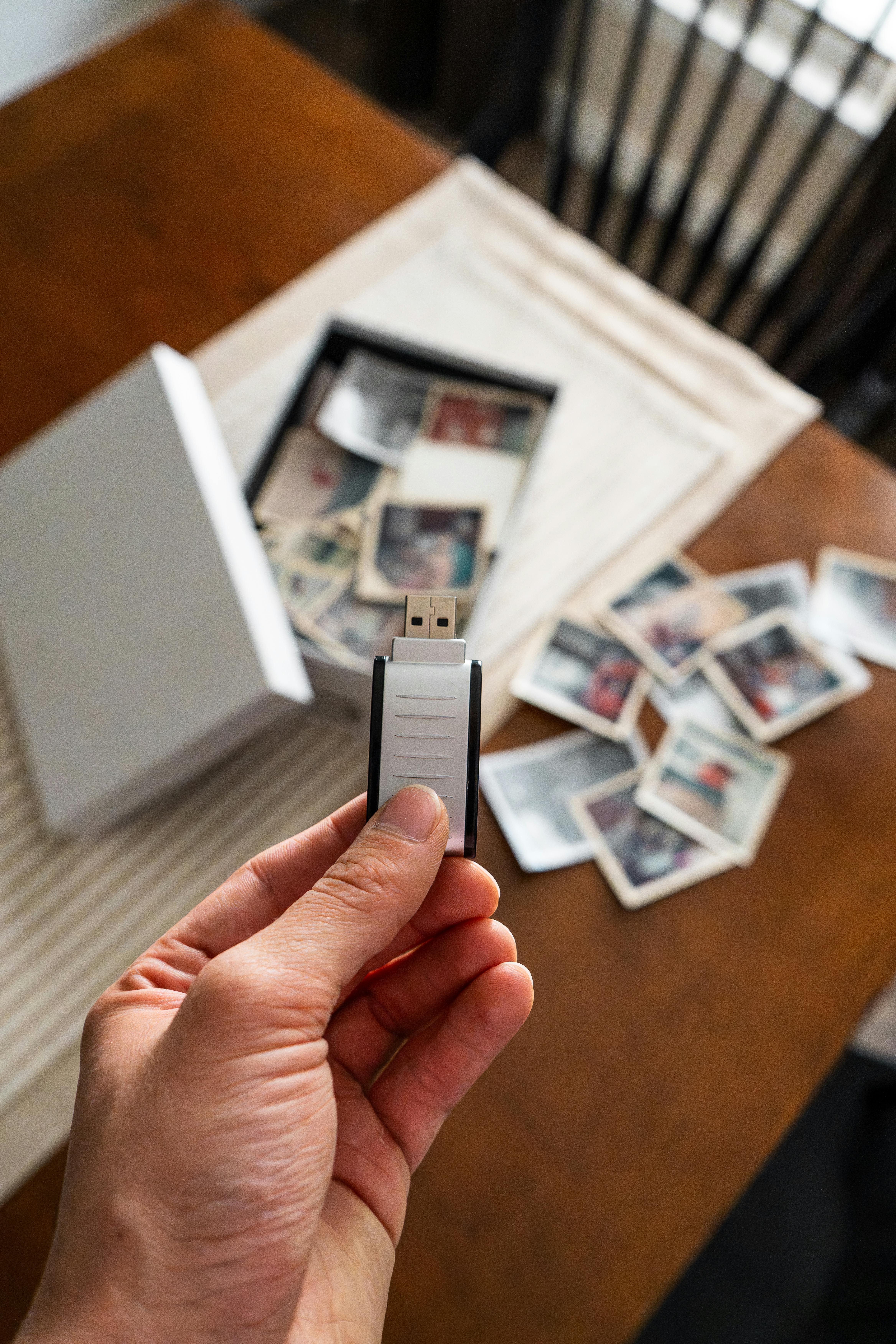 Printed photographs and a USB drive showing the digitization process
